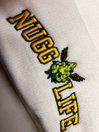 a close up of a pair of socks with the word nug life on them